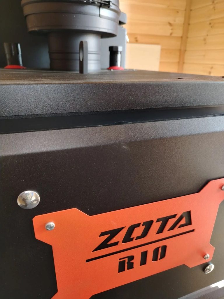Корпус котла ZOTA RIO и место подключения дымохода крупным планом.